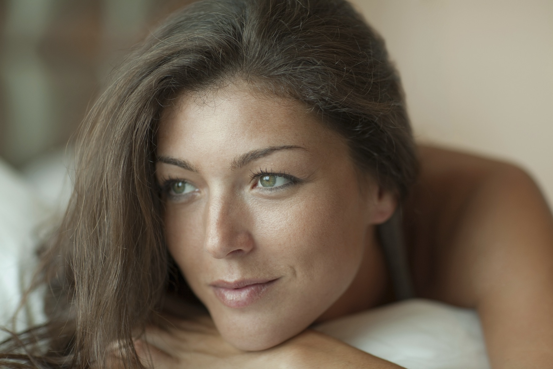 A woman with healthy, radiant skin in soft natural light